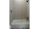 Modern tiled bathroom with bathtub and shower fixture at 2590 Silas Peak Ln, Apex, NC 27523