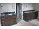 Bathroom featuring dual vanities with dark countertops and stylish light fixtures at 2590 Silas Peak Ln, Apex, NC 27523