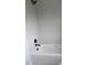 Clean white bathtub with a mounted shower head and a modern design at 2590 Silas Peak Ln, Apex, NC 27523