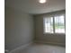 Bedroom featuring a window that provides natural light with light colored walls and flooring at 2590 Silas Peak Ln, Apex, NC 27523