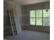 Unfinished bedroom featuring lots of light and four hinged doors ready for installation at 2590 Silas Peak Ln, Apex, NC 27523