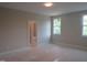 Bedroom with lots of natural light and an open doorway leading to another room at 2590 Silas Peak Ln, Apex, NC 27523