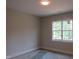 This bedroom features a large window with natural light, neutral walls, and white trim at 2590 Silas Peak Ln, Apex, NC 27523