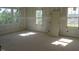 Bedroom with large windows providing lots of natural light and four hinged doors ready for installation at 2590 Silas Peak Ln, Apex, NC 27523