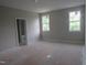 Bright bedroom with large windows offering natural light and a view of the outdoors at 2590 Silas Peak Ln, Apex, NC 27523