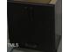 The dark cabinet has recessed pulls with a silver finish and is well lit at 2590 Silas Peak Ln, Apex, NC 27523