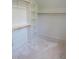 Walk-in closet featuring white built in shelving and a natural wood closet rod at 2590 Silas Peak Ln, Apex, NC 27523