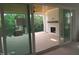 View of a covered deck with a fireplace and a view of a wooded backyard at 2590 Silas Peak Ln, Apex, NC 27523