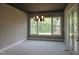 Bright dining room with modern chandelier and large windows offering a view of the outdoors at 2590 Silas Peak Ln, Apex, NC 27523