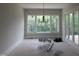 Bright dining room with large windows and stylish chandelier at 2590 Silas Peak Ln, Apex, NC 27523