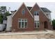 Stunning new construction featuring brick and siding, complemented by large windows and modern design elements at 2590 Silas Peak Ln, Apex, NC 27523