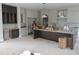 Bright and airy kitchen showcasing modern cabinetry, stainless steel appliances, and arched entryway at 2590 Silas Peak Ln, Apex, NC 27523
