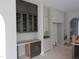Custom kitchen with dark wood and white cabinets, plus built-in desk at 2590 Silas Peak Ln, Apex, NC 27523