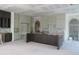 Unfinished kitchen with custom cabinetry, spacious layout, and ample natural light, perfect for creating culinary masterpieces at 2590 Silas Peak Ln, Apex, NC 27523