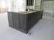The kitchen island boasts custom cabinetry and counter space, offering both functionality and style in this unfinished space at 2590 Silas Peak Ln, Apex, NC 27523