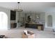 Open-concept kitchen featuring arched doorways, a kitchen island, and modern cabinetry at 2590 Silas Peak Ln, Apex, NC 27523