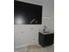 Modern laundry room featuring dark cabinets, a sink, and a convenient space for laundry appliances at 2590 Silas Peak Ln, Apex, NC 27523