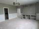 Spacious living area with built-ins and wainscotting offering versatile layout options at 2590 Silas Peak Ln, Apex, NC 27523