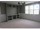 Stylish living area with custom built-ins, a window, and a modern lighting fixture at 2590 Silas Peak Ln, Apex, NC 27523