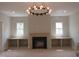 Elegant living room with fireplace, custom built-ins, and abundant natural light at 2590 Silas Peak Ln, Apex, NC 27523