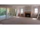 Spacious living room with a fireplace, built-in shelving, and sliding glass doors to the deck at 2590 Silas Peak Ln, Apex, NC 27523