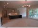 Modern kitchen with a dark island, leading to an open-concept living space at 2590 Silas Peak Ln, Apex, NC 27523