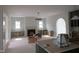 Bright, open living room with fireplace, built-in shelves, and access to a covered outdoor deck at 2590 Silas Peak Ln, Apex, NC 27523