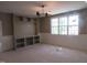 Open concept living room featuring large windows, built in shelving, and modern lighting at 2590 Silas Peak Ln, Apex, NC 27523