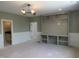 Open concept living room featuring built in shelving and modern lighting at 2590 Silas Peak Ln, Apex, NC 27523
