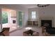 Bright living room with fireplace, built-ins, sliding doors to covered deck, and modern chandelier at 2590 Silas Peak Ln, Apex, NC 27523