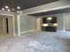 Spacious unfinished living room with a unique light fixture and wet bar offers a great place to entertain at 2590 Silas Peak Ln, Apex, NC 27523