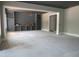Open-concept living room with built-in shelving and large windows at 2590 Silas Peak Ln, Apex, NC 27523