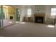 Bright living area with built-ins, fireplace, and sliding doors to a covered outdoor deck at 2590 Silas Peak Ln, Apex, NC 27523