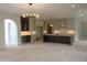 Spacious kitchen with island, and leads to an open-concept living space with modern light fixture at 2590 Silas Peak Ln, Apex, NC 27523