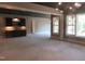 Unfinished living room with a wet bar, dark cabinets, and a unique light fixture at 2590 Silas Peak Ln, Apex, NC 27523