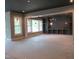 Unfinished living room features large windows, gray walls, and a unique light fixture at 2590 Silas Peak Ln, Apex, NC 27523