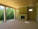 Spacious covered porch features a wood-burning fireplace and serene views of the yard at 2590 Silas Peak Ln, Apex, NC 27523