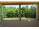 Open porch with wood ceiling and black metal railing overlooking beautiful trees at 2590 Silas Peak Ln, Apex, NC 27523