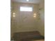 New shower with glass door, dual shower heads, and built-in shelving at 2590 Silas Peak Ln, Apex, NC 27523