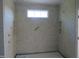 Tiled shower stall featuring recessed shelves and a window at 2590 Silas Peak Ln, Apex, NC 27523