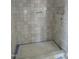 Sleek, tiled shower, designed with modern aesthetics and offering a luxurious showering experience at 2590 Silas Peak Ln, Apex, NC 27523