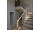 Contemporary staircase with oak and black metal railing leading to second story at 2590 Silas Peak Ln, Apex, NC 27523