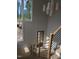 Contemporary foyer with striking staircase, wooden front door and bright windows, providing a warm, inviting atmosphere at 2590 Silas Peak Ln, Apex, NC 27523