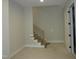 Modern staircase with metal railing stands near the doorway of this unfinished home's interior at 2590 Silas Peak Ln, Apex, NC 27523