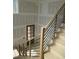 Staircase featuring oak steps, contemporary black metal railings, and natural light at 2590 Silas Peak Ln, Apex, NC 27523