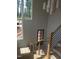 Staircase with wood and metal railing down to glass-paned exterior door and large, bright window at 2590 Silas Peak Ln, Apex, NC 27523
