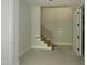 Modern staircase with wooden steps and black metal railing in a bright, unfinished home at 2590 Silas Peak Ln, Apex, NC 27523