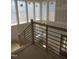 Staircase featuring oak steps, contemporary black metal railings, and natural light at 2590 Silas Peak Ln, Apex, NC 27523