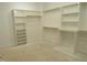 Spacious walk-in closet with a comprehensive shelving and rod system at 2590 Silas Peak Ln, Apex, NC 27523