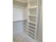 Bright walk-in closet features custom shelving and rod system for optimal organization at 2590 Silas Peak Ln, Apex, NC 27523